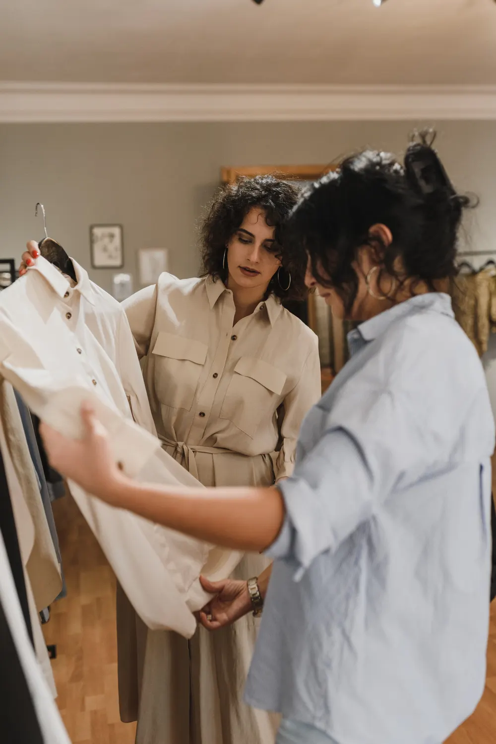 Two women looking at clothes in a boutique